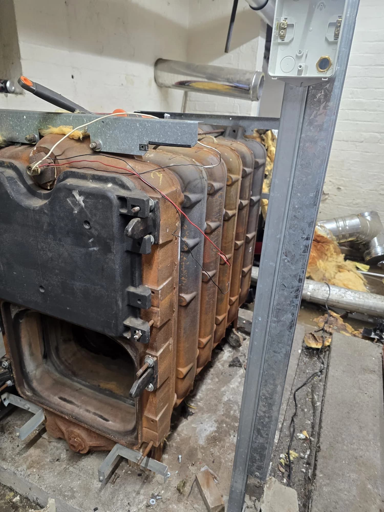 Cast iron sectional boiler in a plant room during removal