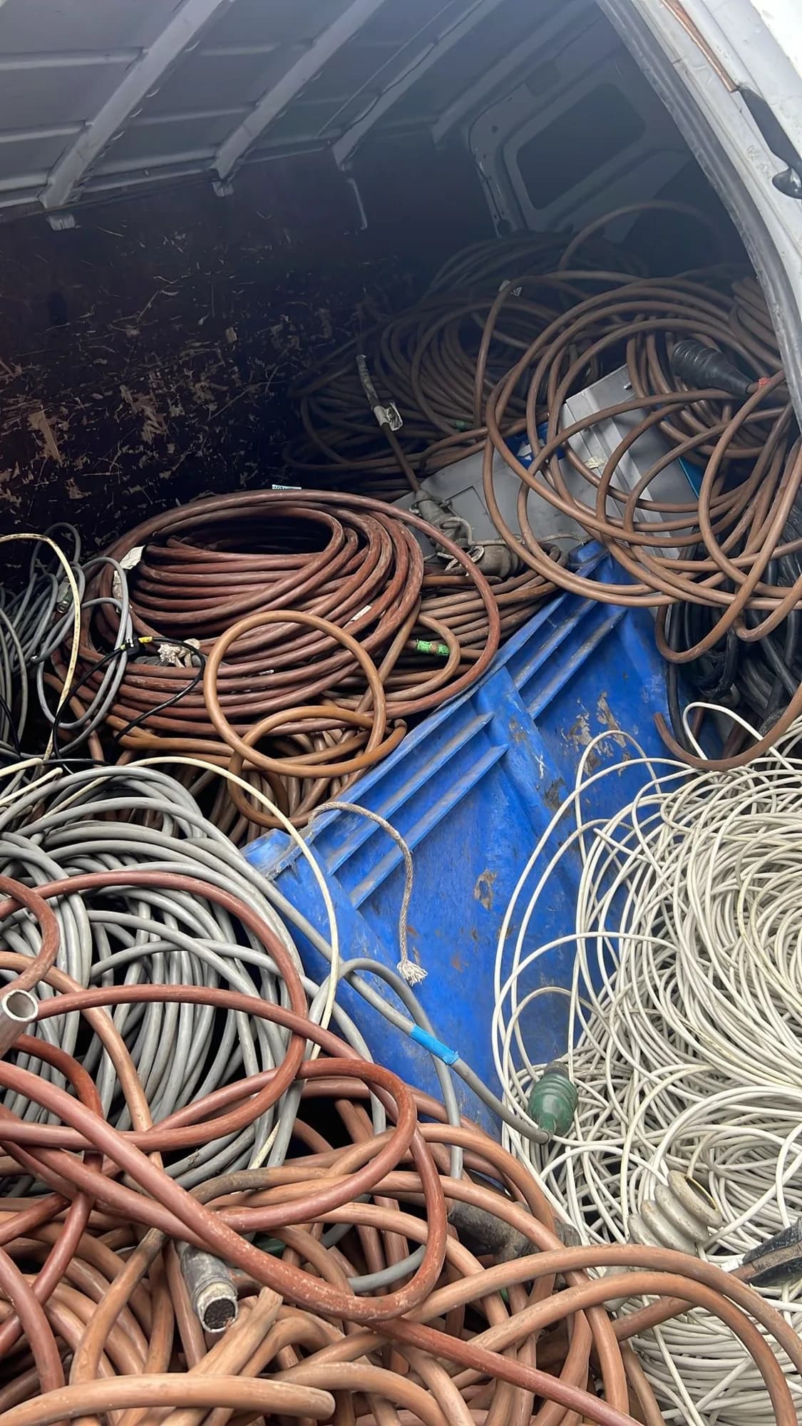 Inside the Avram van, loaded with coils of copper-coloured and grey cable